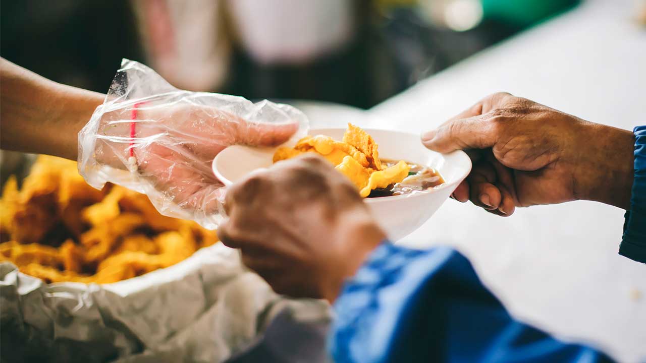 volunteers scooping food