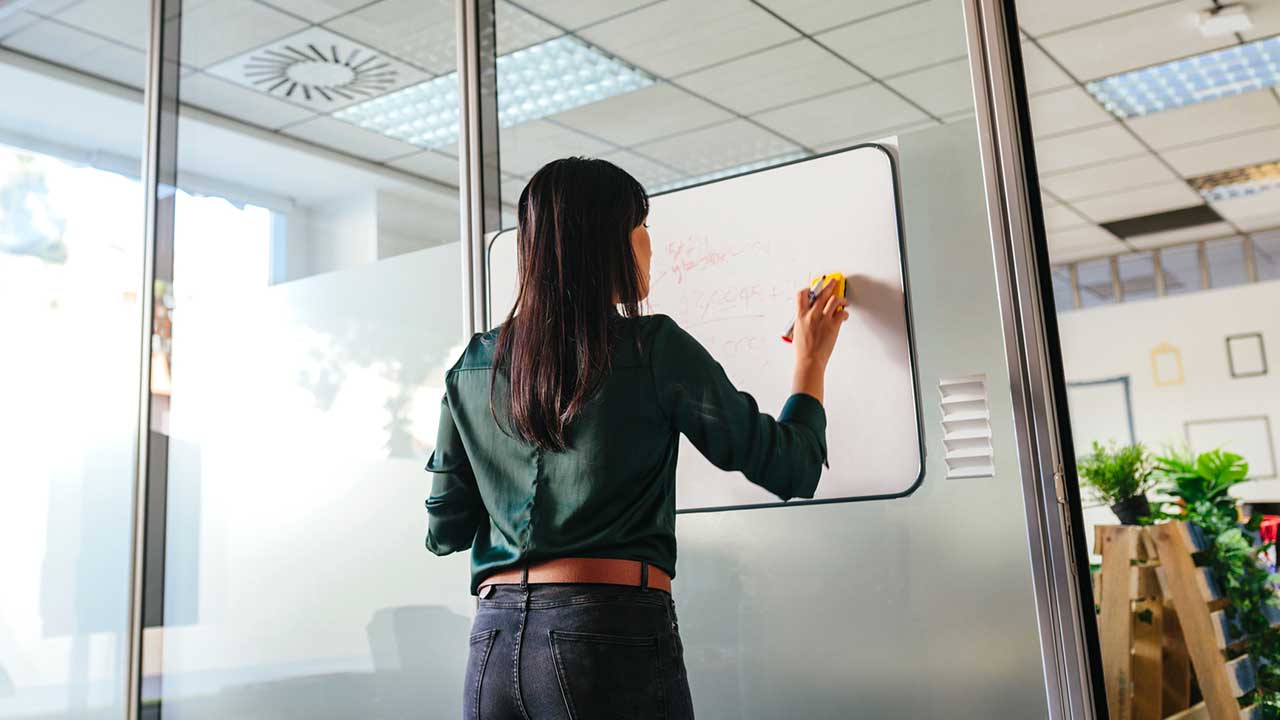 woman writing on whiteboard