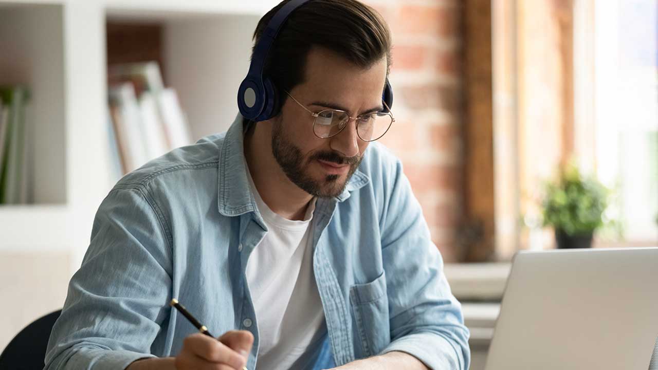 young man watching educational training on a computer