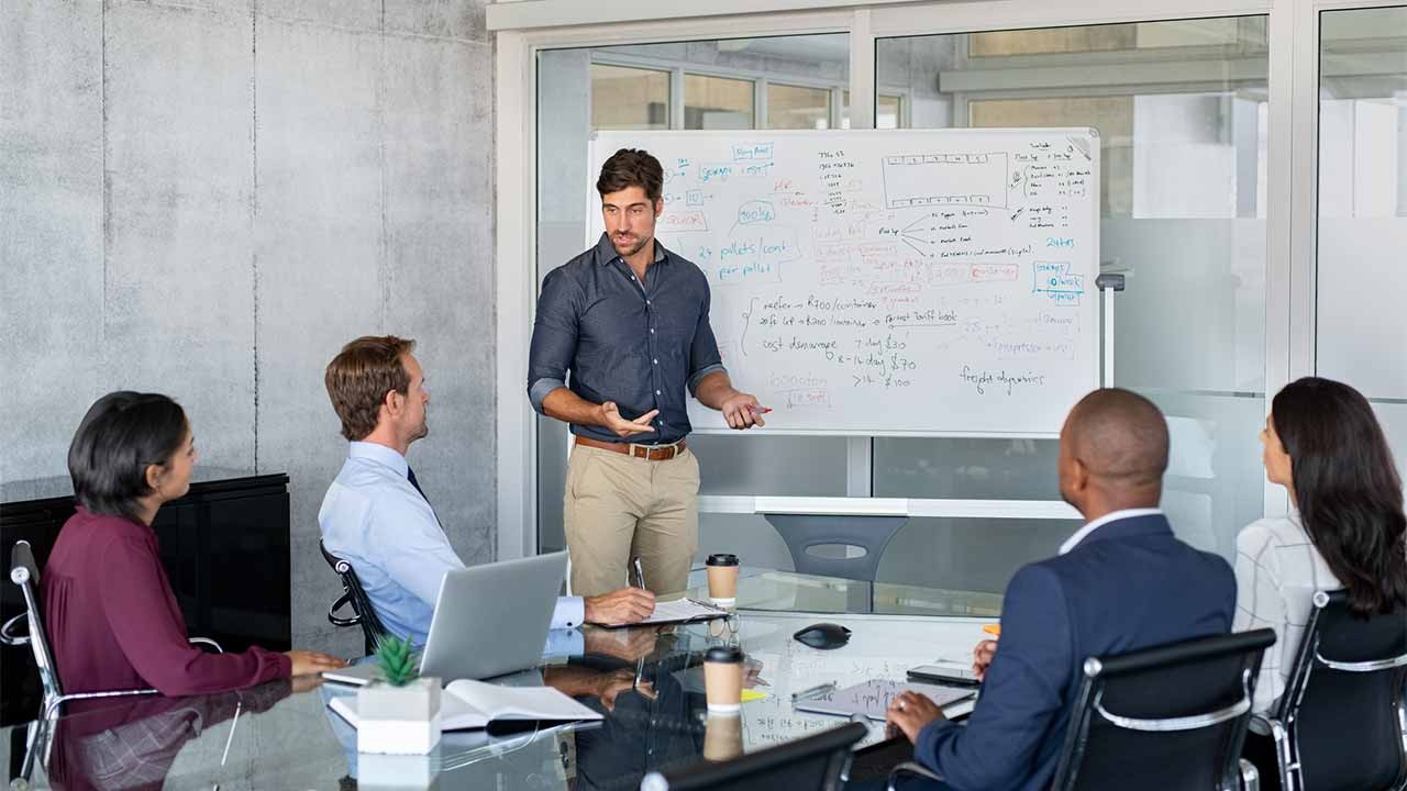man giving presentation to business partners